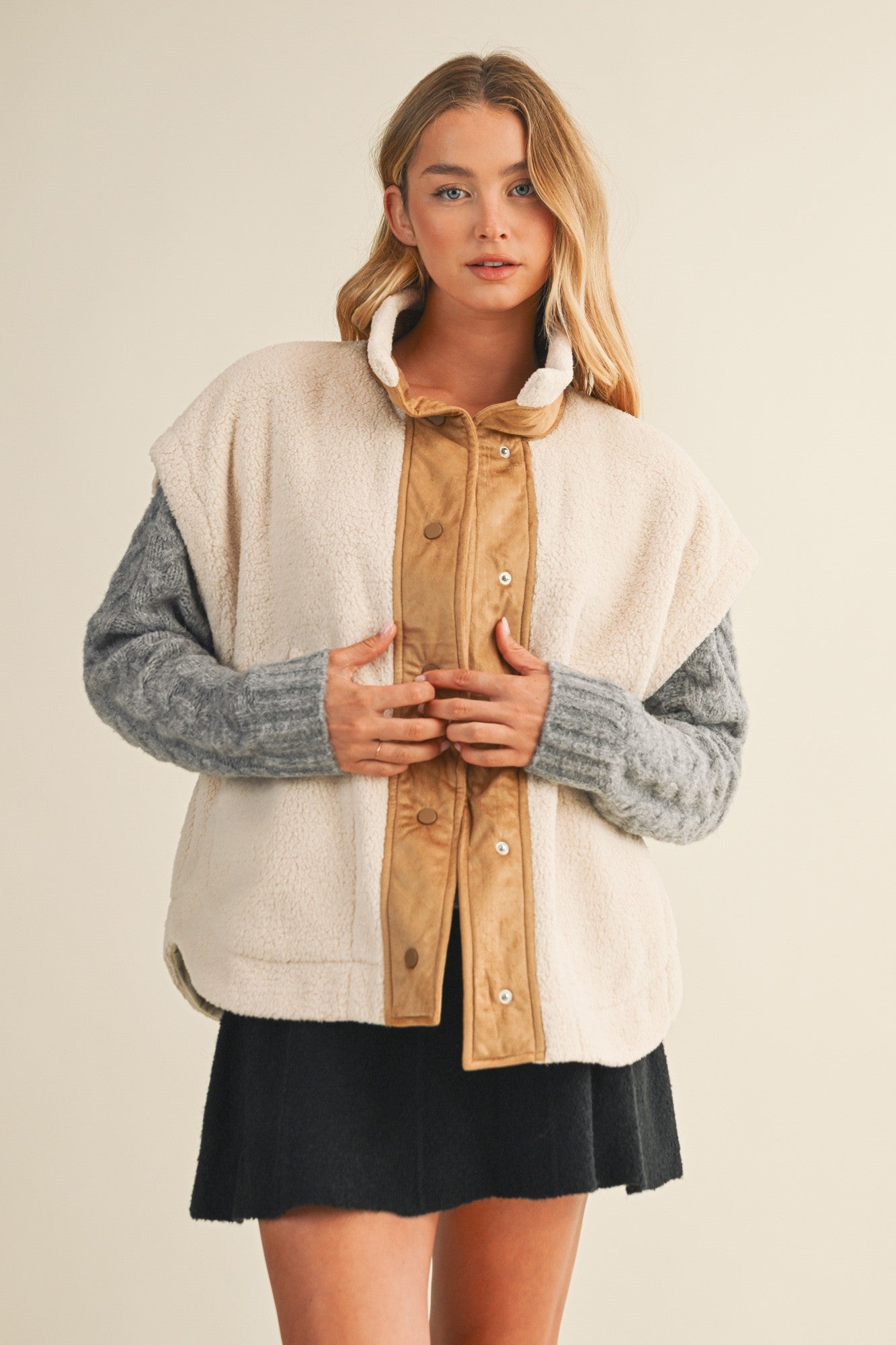 Front lifestyle view of model wearing the Harper Cozy Snap Vest in ecru with mock neck and snap closure