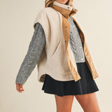 Full-body side view of model wearing the ecru snap vest, showing length and layering fit