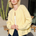 Woman wearing the Harper Round-Neck Relaxed Cardigan in butter yellow with a skirt — stylish, cozy women’s knit cardigan.