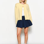 Full view of the Harper Round-Neck Relaxed Cardigan in butter yellow — soft, cozy knit with slightly oversized silhouette.