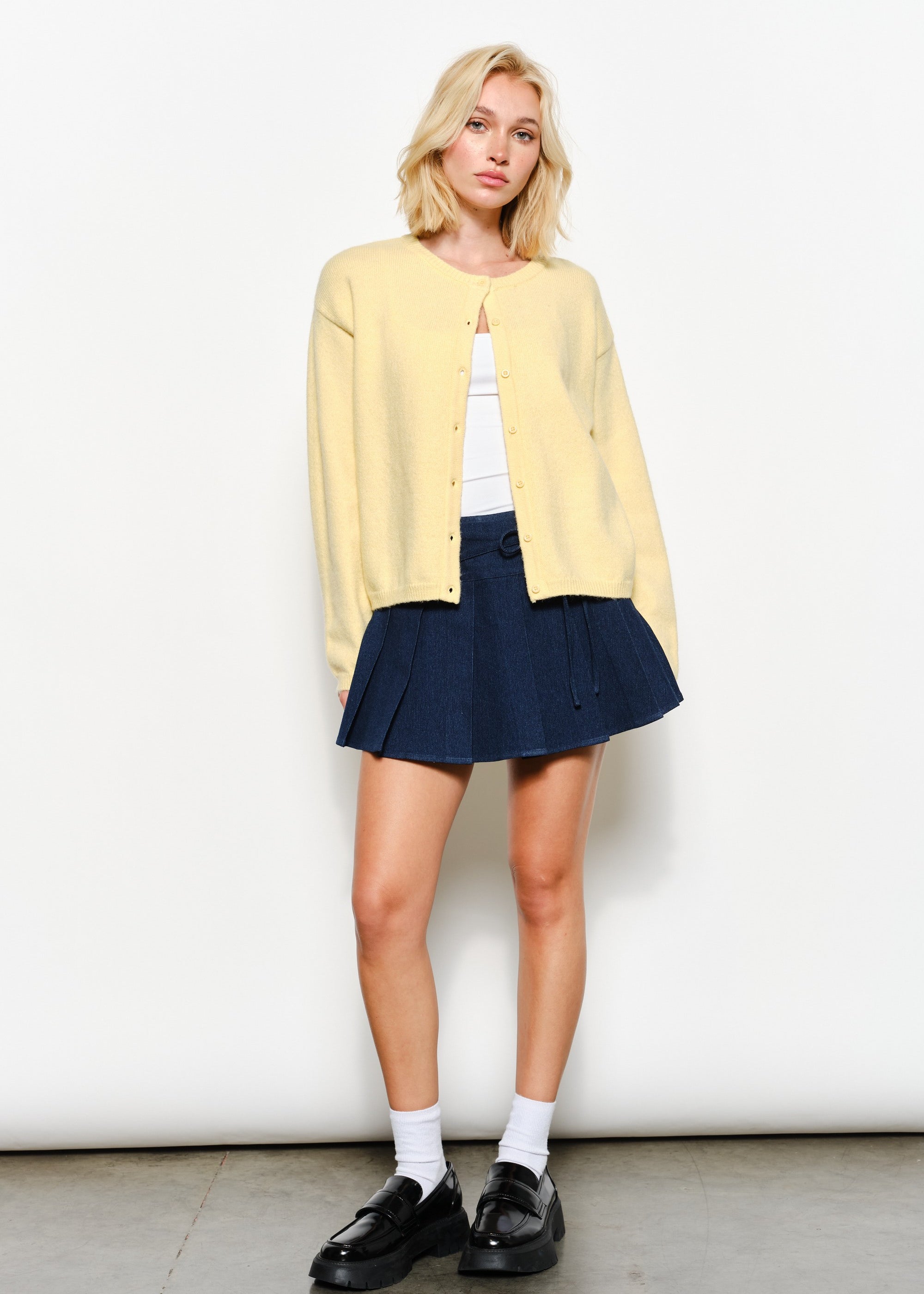Full view of the Harper Round-Neck Relaxed Cardigan in butter yellow — soft, cozy knit with slightly oversized silhouette.