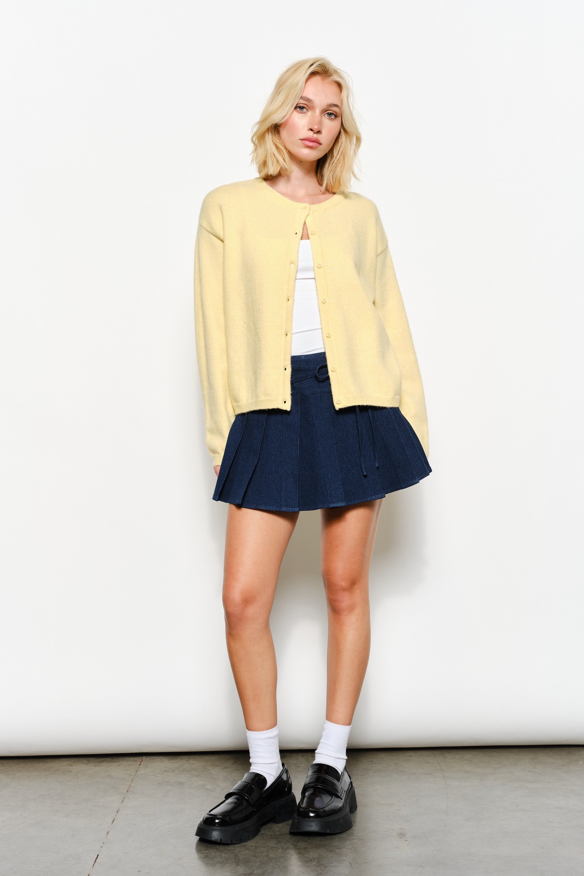 Full view of the Harper Round-Neck Relaxed Cardigan in butter yellow — soft, cozy knit with slightly oversized silhouette.