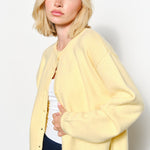 Side view of the Harper Round-Neck Relaxed Cardigan in butter yellow — soft, cozy knit with slightly oversized silhouette.