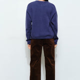 Back of the Harper Round-Neck Relaxed Cardigan in navy — relaxed knit texture with ribbed cuffs and hem.