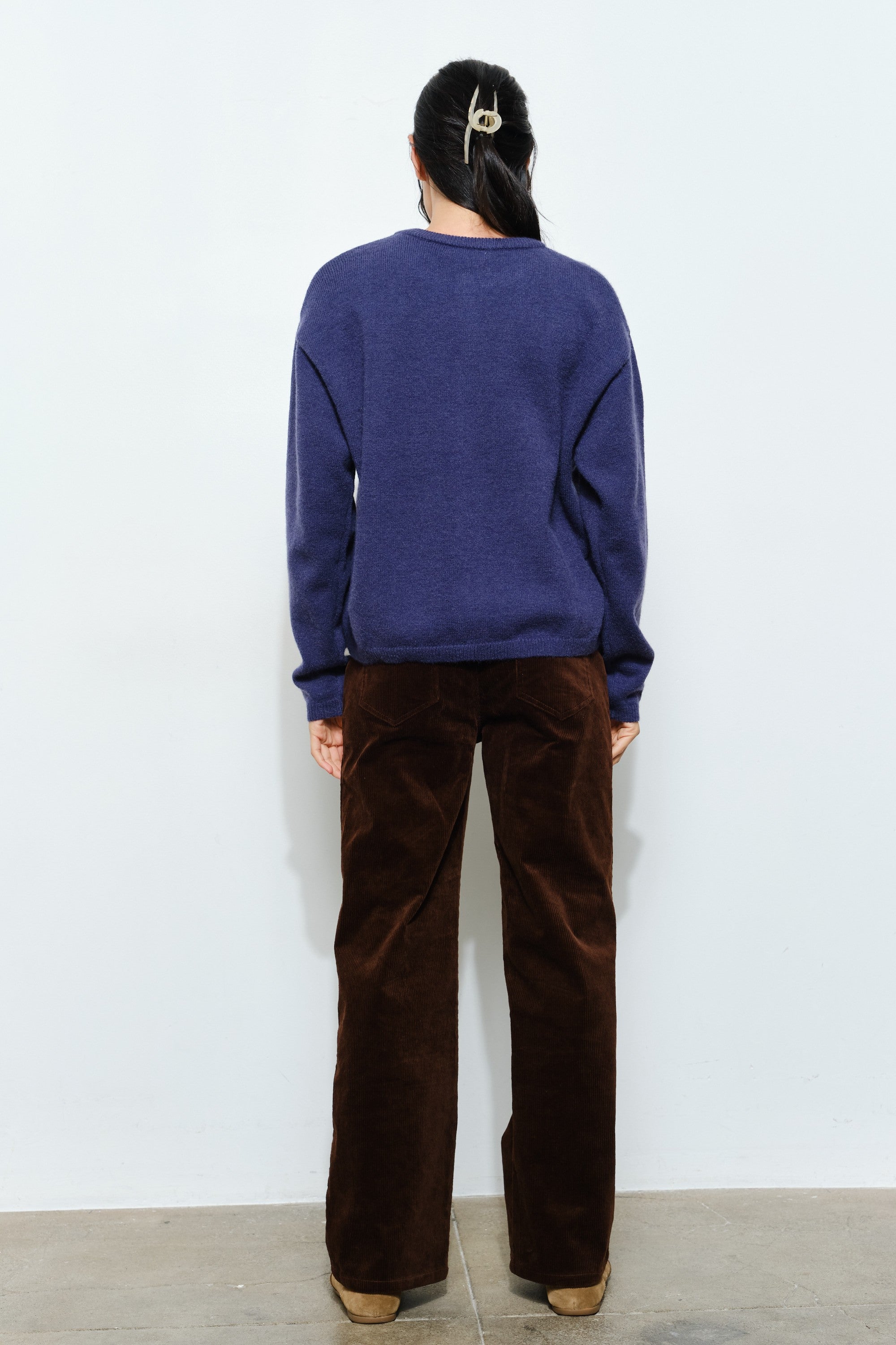 Back of the Harper Round-Neck Relaxed Cardigan in navy — relaxed knit texture with ribbed cuffs and hem.