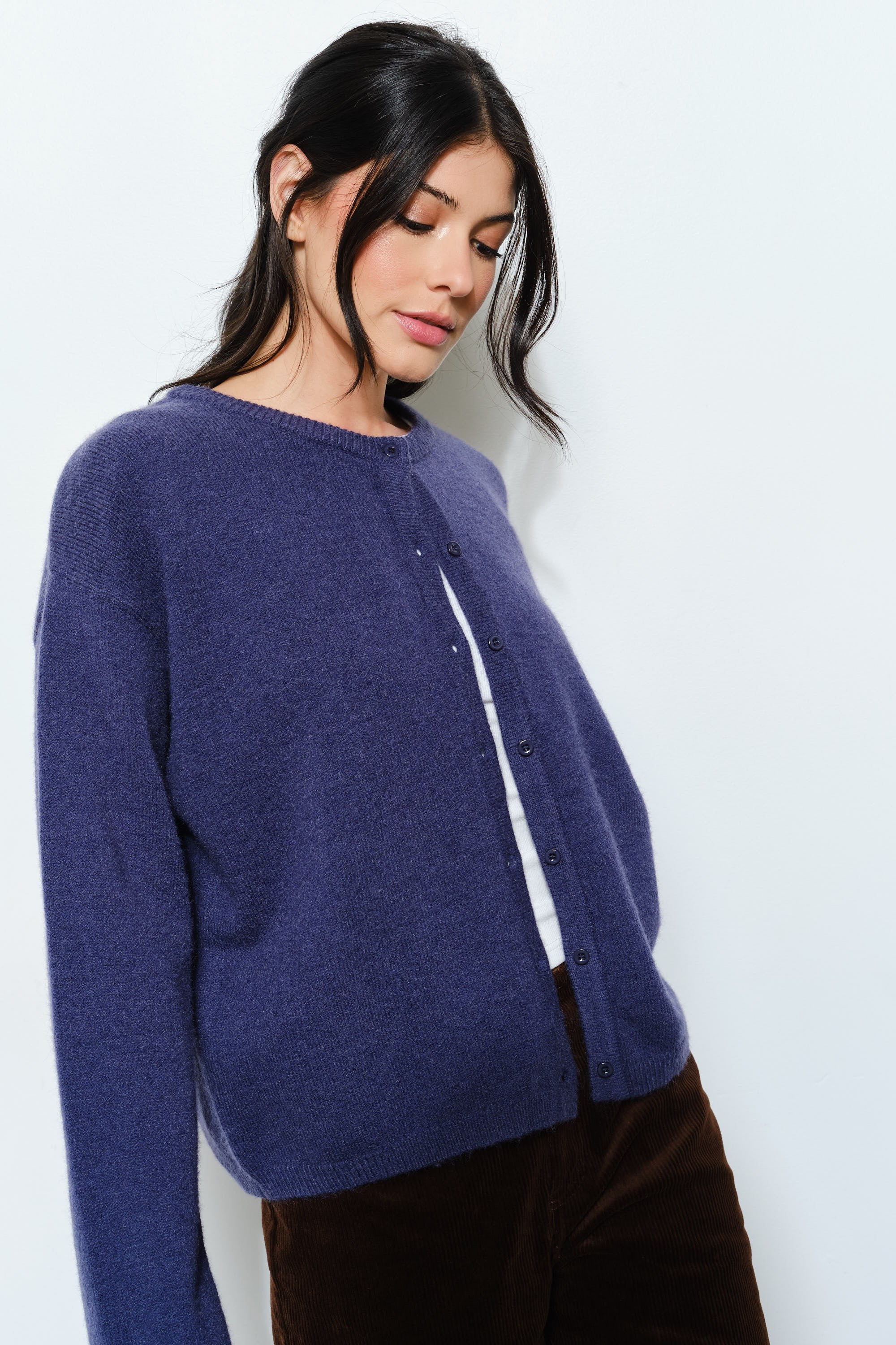 Side view of the Harper Round-Neck Relaxed Cardigan in navy — soft, cute cozy knit with an oversized silhouette.
