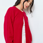 Side view of the Harper Round-Neck Relaxed Cardigan in red — soft, lightweight knit with oversized silhouette.