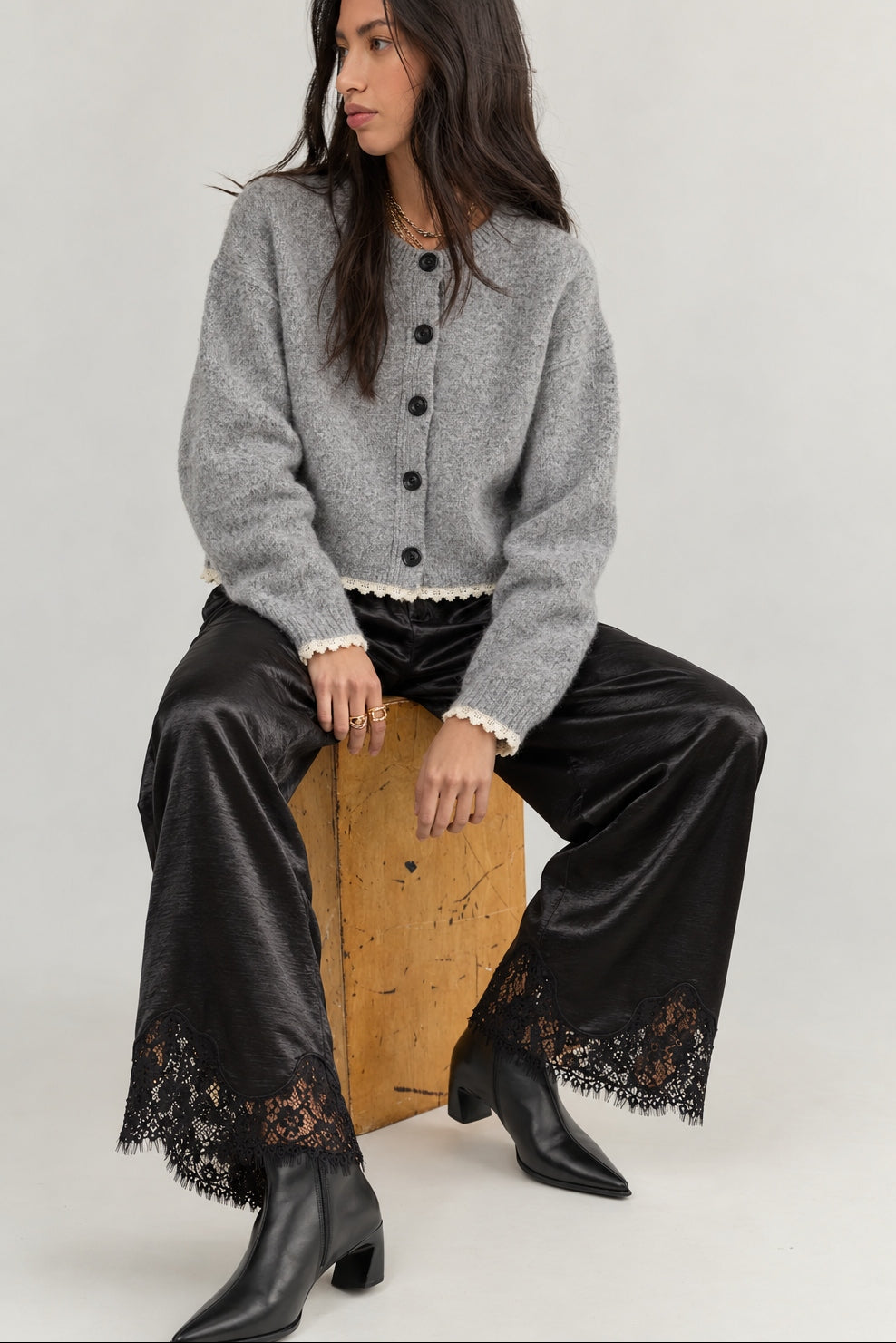 Model wearing Heirloom black satin lace wide-leg pants with a gray cardigan.