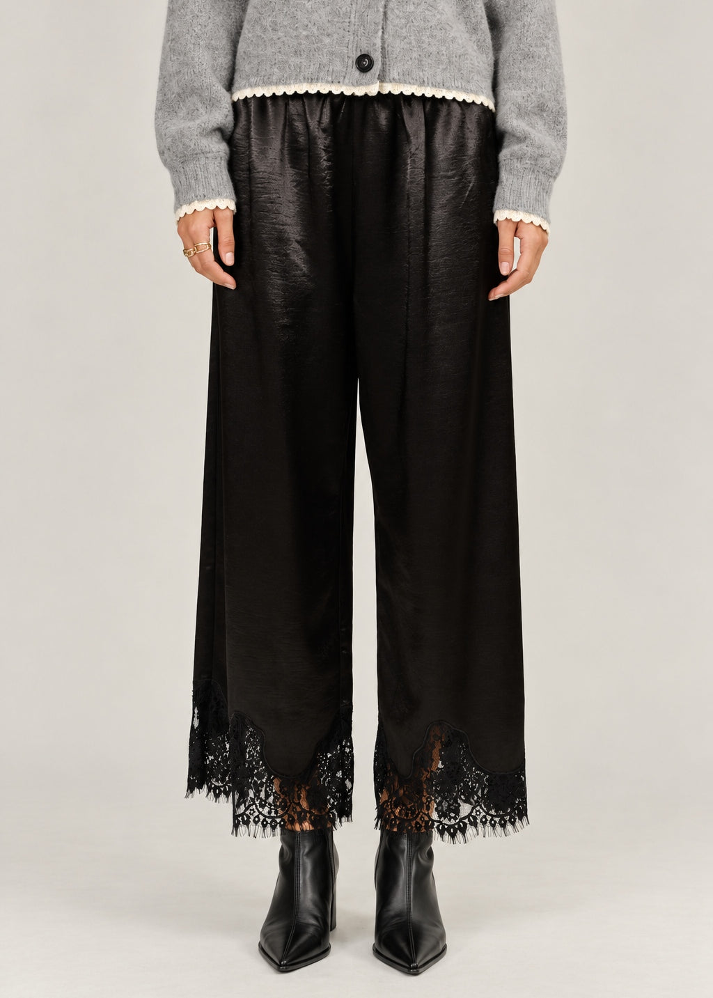  Heirloom black satin pants showing the wide cut and delicate lace hems.