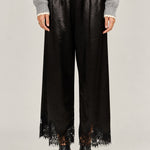  Heirloom black satin pants showing the wide cut and delicate lace hems.