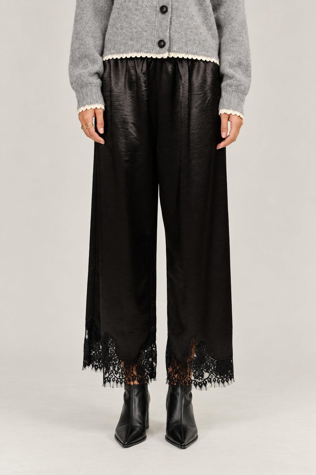  Heirloom black satin pants showing the wide cut and delicate lace hems.