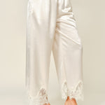 Side view of champagne satin wide-leg pants with soft drape and lace trim hem