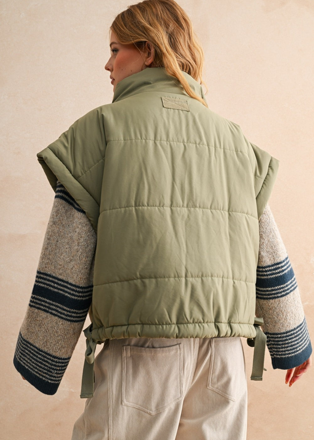Back of olive bubble puffer vest with longline silhouette and soft quilted texture — lightweight women’s winter vest.
