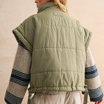 Back of olive bubble puffer vest with longline silhouette and soft quilted texture — lightweight women’s winter vest.