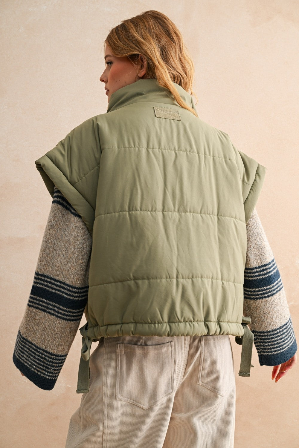 Back of olive bubble puffer vest with longline silhouette and soft quilted texture — lightweight women’s winter vest.