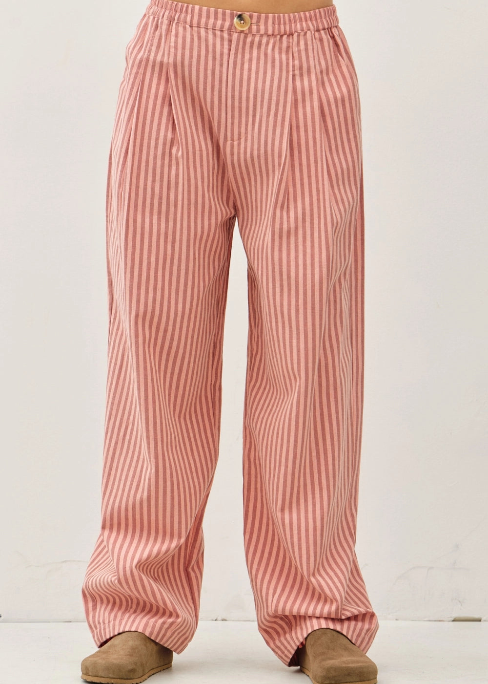 Irene Striped Wide Leg Pants in Blush front view showing the elastic waistband, button closure, front pleats, and wide leg fit.