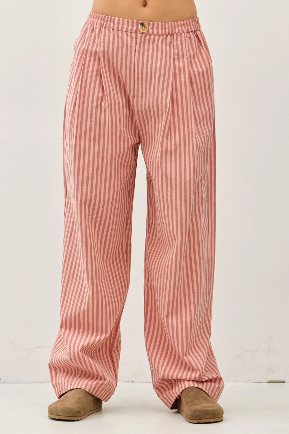 Irene Striped Wide Leg Pants in Blush front view showing the elastic waistband, button closure, front pleats, and wide leg fit.