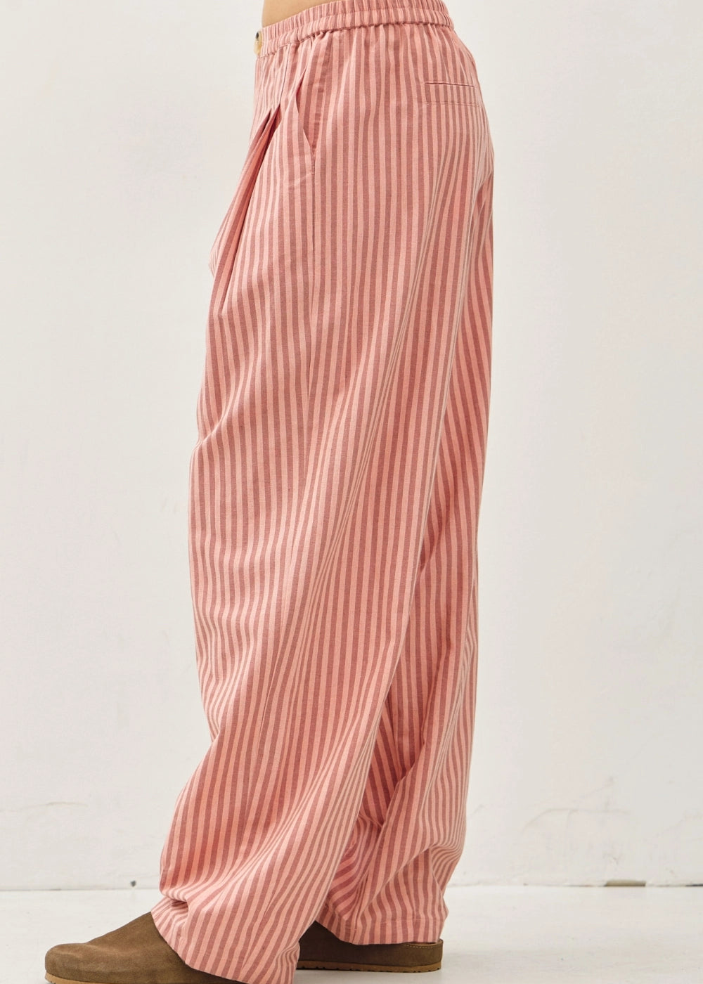 Side view of the Irene Striped Wide Leg Pants in Blush with a relaxed wide leg silhouette and soft striped cotton-linen fabric.