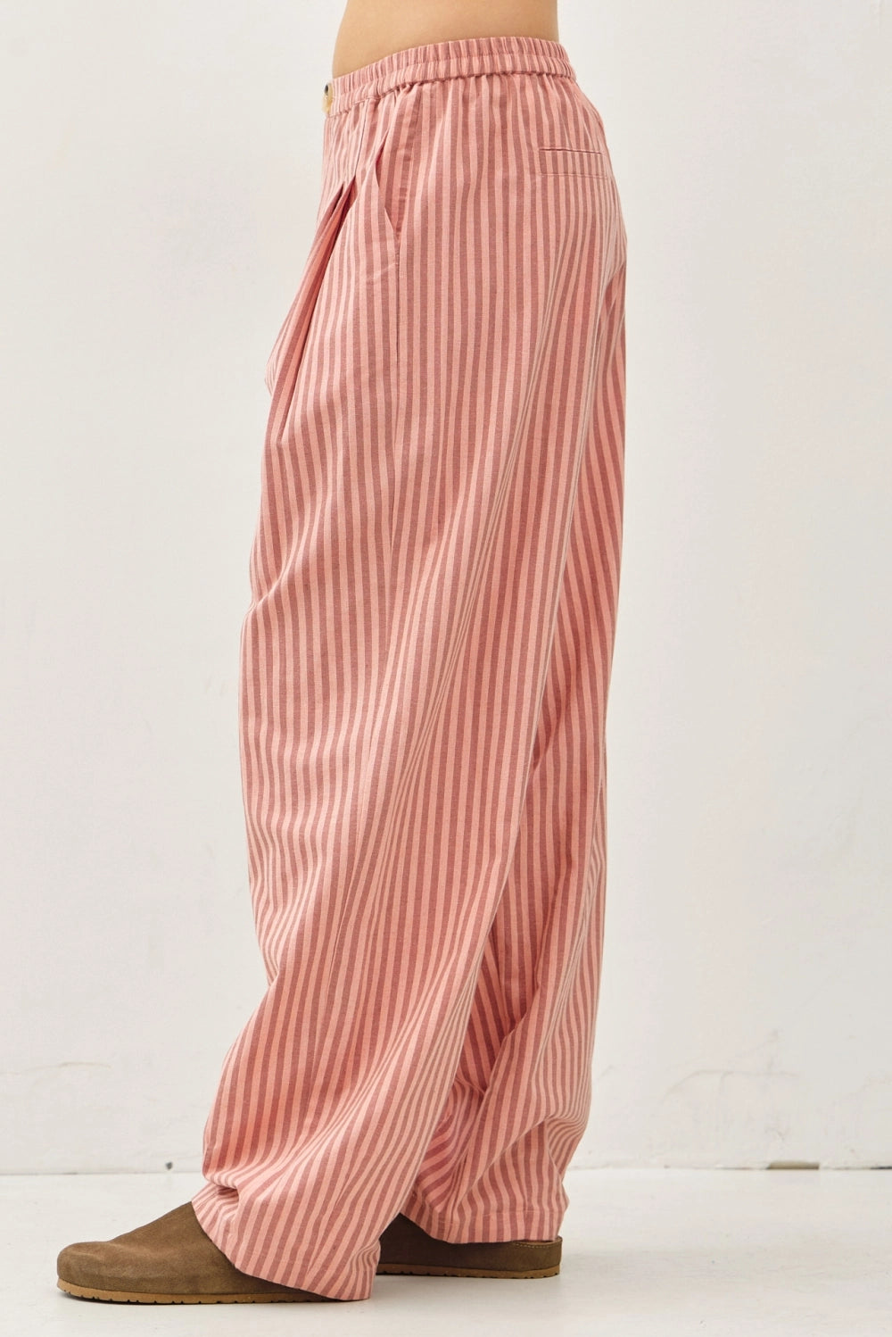 Side view of the Irene Striped Wide Leg Pants in Blush with a relaxed wide leg silhouette and soft striped cotton-linen fabric.
