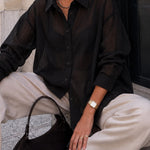 Side view of woman wearing the relaxed sheer pinstripe button-down shirt
