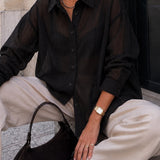 Side view of woman wearing the relaxed sheer pinstripe button-down shirt