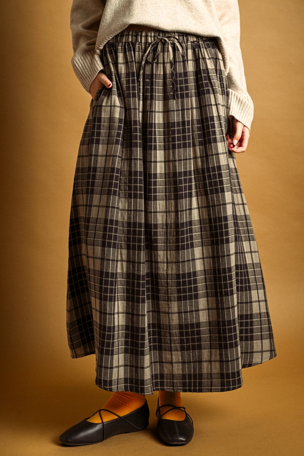 Front view of Ives plaid A-line maxi skirt with drawstring waist and pockets