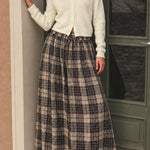 Lifestyle image of Ives plaid A-line maxi skirt with drawstring waist and pockets