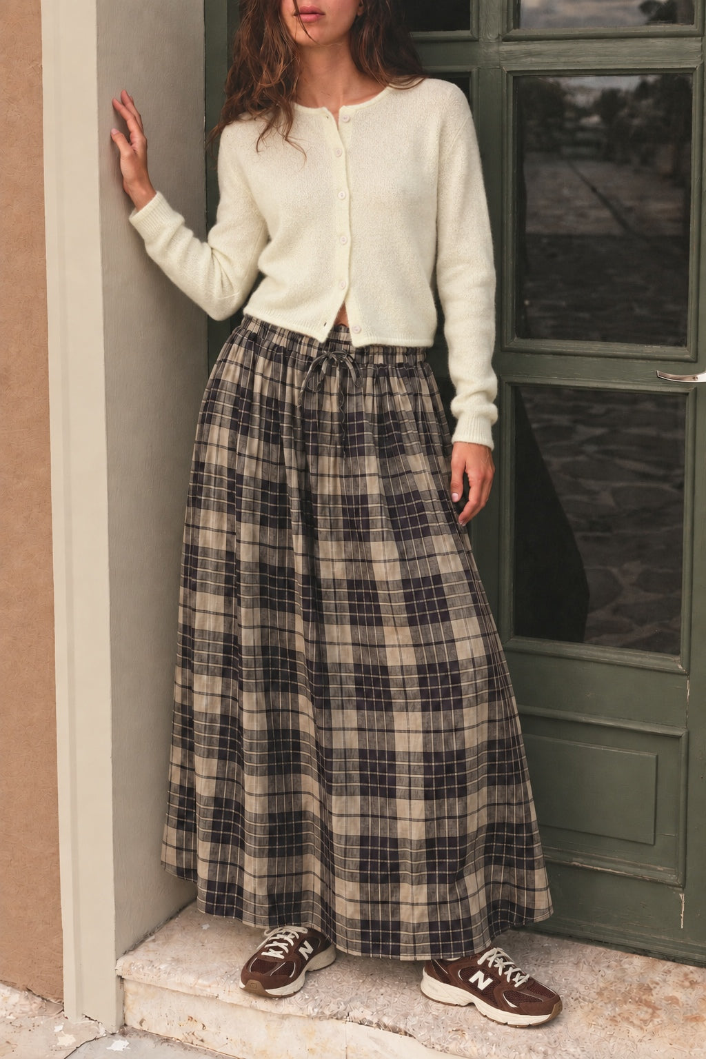 Lifestyle image of Ives plaid A-line maxi skirt with drawstring waist and pockets