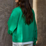 Back view of the Jetset varsity green twofer sweatshirt, showing its relaxed fit and dropped shoulders.