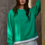 Front view of the Jetset varsity green layered crewneck sweatshirt with white contrast trim at the neckline and hem.