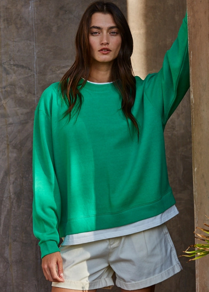Front view of the Jetset varsity green layered crewneck sweatshirt with white contrast trim at the neckline and hem.