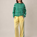 Full outfit of butter yellow Landon Track Pants showing the blue stripe detail and relaxed pull-on fit.