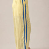 Side view of butter yellow Landon Track Pants 