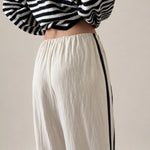 Close up back view of ivory Landon Side Stripe Track Pants showing the contrast blue stripe and relaxed pull-on fit.