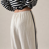 Close up back view of ivory Landon Side Stripe Track Pants showing the contrast blue stripe and relaxed pull-on fit.