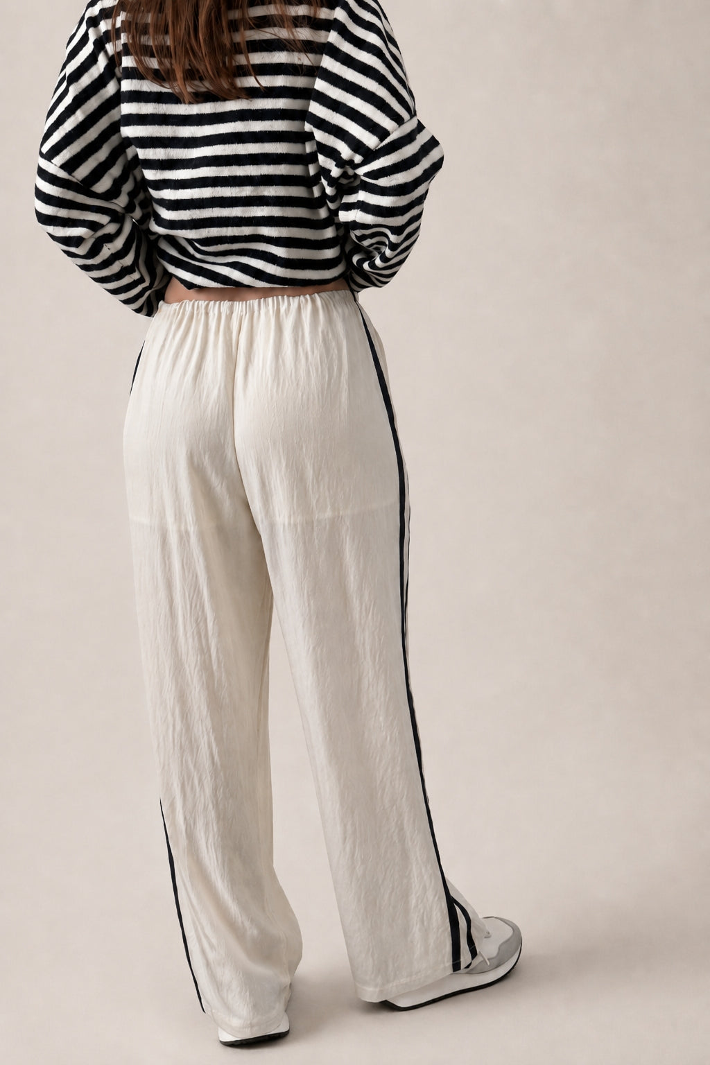 back view of ivory Landon Side Stripe Track Pants showing the contrast blue stripe and relaxed pull-on fit.