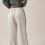 back view of ivory Landon Side Stripe Track Pants showing the contrast blue stripe and relaxed pull-on fit.