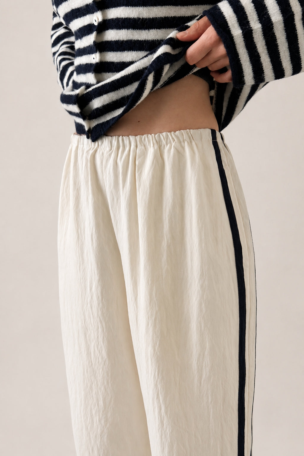 Close-up of the ivory Landon Track Pants with soft elastic waistband and easy pull-on design.
