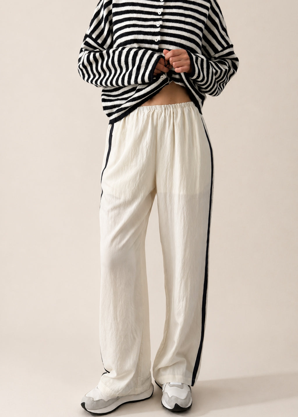 Landon Side Stripe Track Pants in ivory with relaxed wide leg fit, elastic waist, and blue side stripe detail.