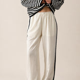 Landon Side Stripe Track Pants in ivory with relaxed wide leg fit, elastic waist, and blue side stripe detail.