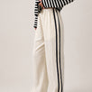 Full length view of the Landon Side Stripe Track Pants in ivory styled for a casual everyday outfit.