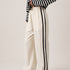 Full length view of the Landon Side Stripe Track Pants in ivory styled for a casual everyday outfit.