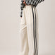 Full length view of the Landon Side Stripe Track Pants in ivory styled for a casual everyday outfit.