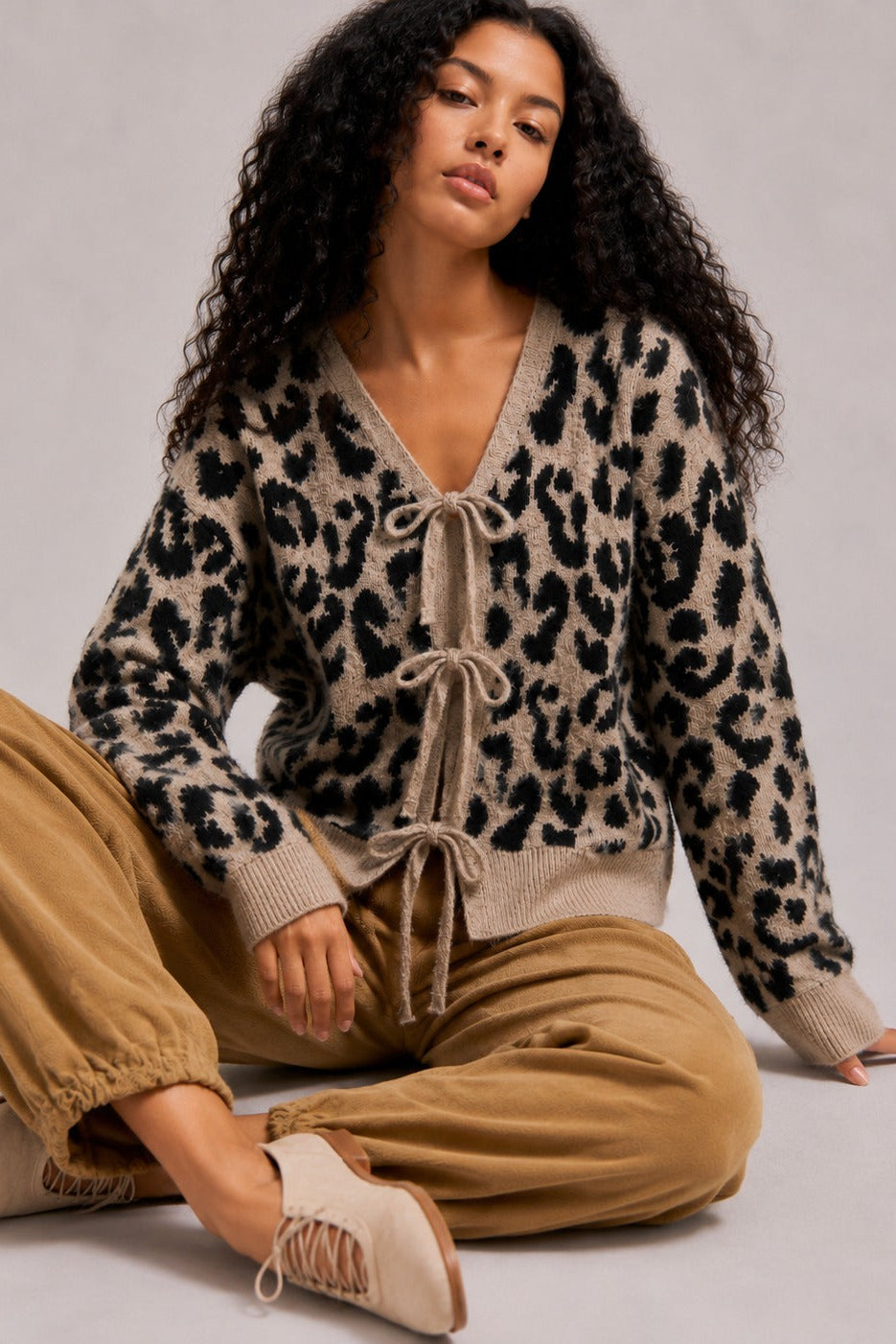 Front view of the mocha black leopard print cardigan sweater with long sleeves and a relaxed fit