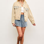 Full body view of light wash casual denim jacket styled with skirt