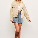 Full body view of light wash casual denim jacket styled with skirt