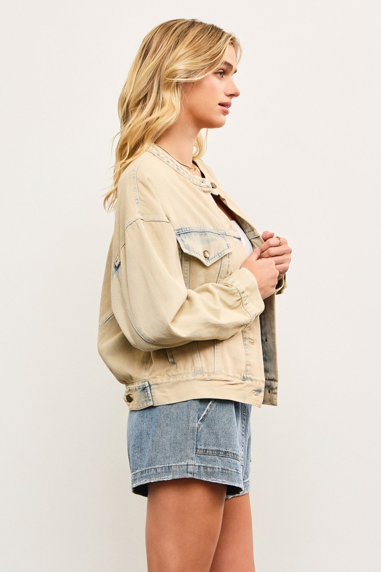 Side view of light wash casual denim jacket showing cropped boxy silhouette