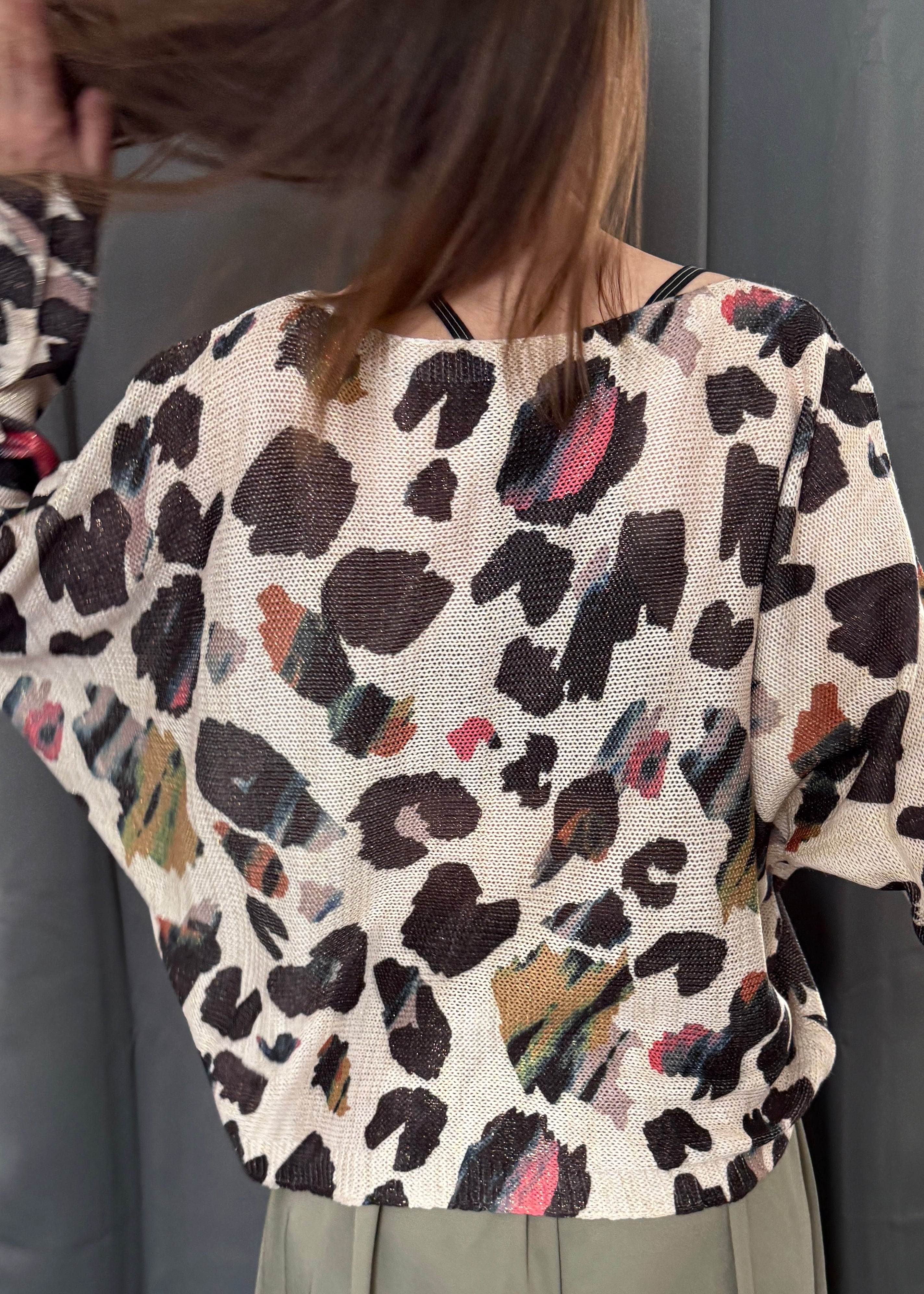 Back view of the abstract leopard batwing sweater showing relaxed silhouette