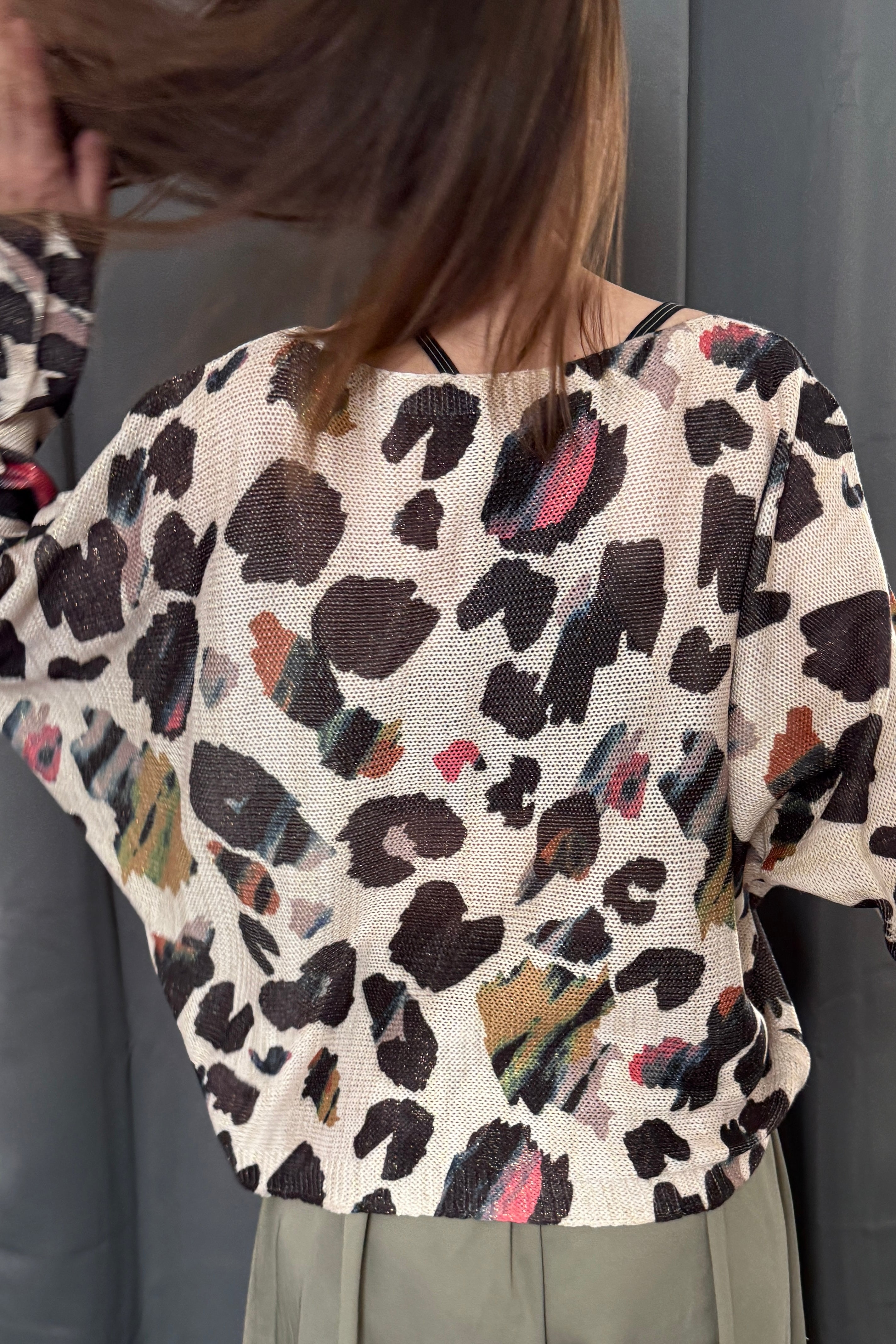 Back view of the abstract leopard batwing sweater showing relaxed silhouette