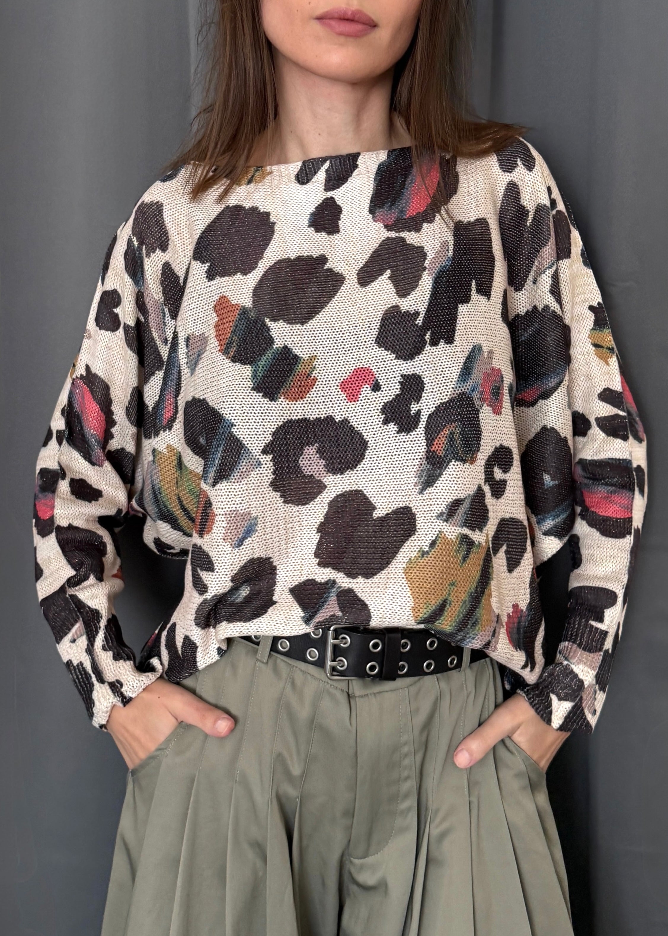 Front portrait of model wearing the Livia Made in Italy batwing printed sweater in abstract leopard multi print